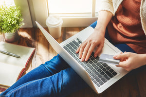 Woman purchasing CBD oil online on her laptop