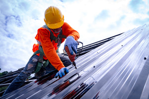 Laborer works on roof where he might be tested for drugs.