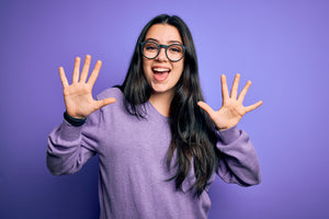 Woman holding up ten fingers for ten things about CBD oil